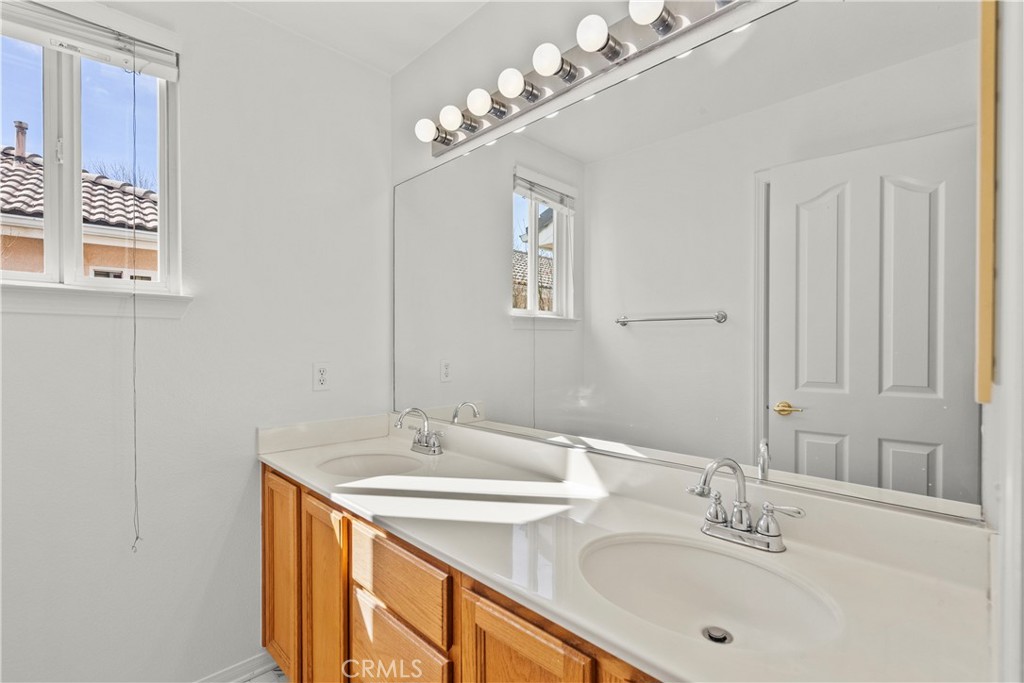 25558 Fitzgerald Avenue Stevenson Ranch, CA 91381 - Photo 42 of 55 a bathroom with a sink double vanity and a mirror