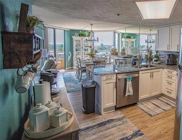 a kitchen with a sink appliances and cabinets