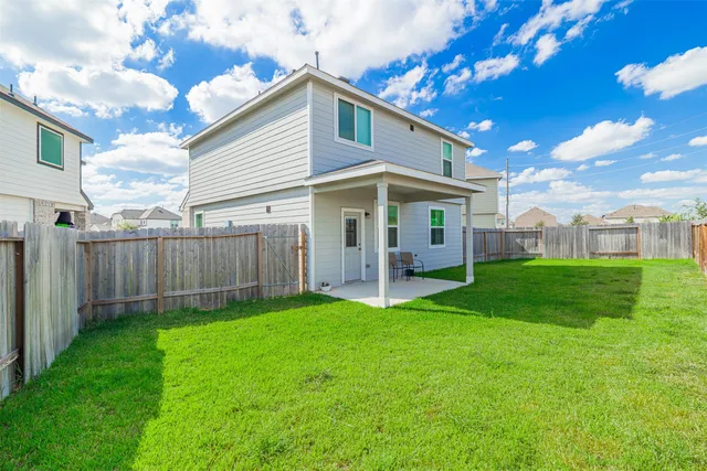 a view of a house with a yard and porch