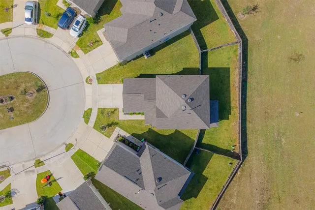 an aerial view of a house with a swimming pool