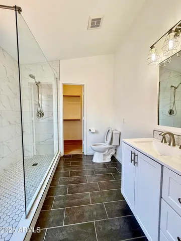 a bathroom with a glass door shower