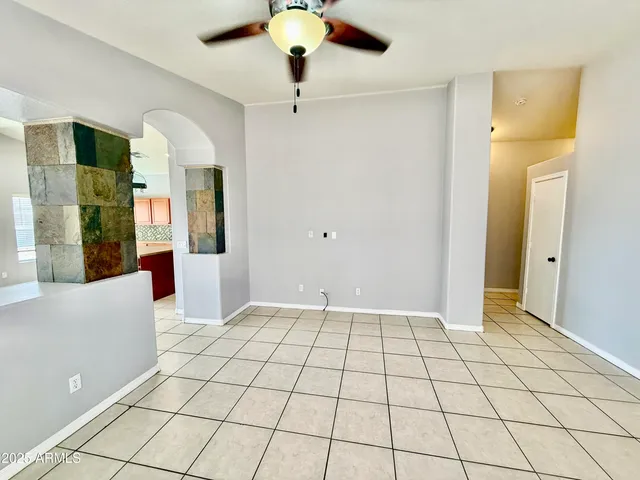 a view of a hallway with wooden floor windows and a chandelier