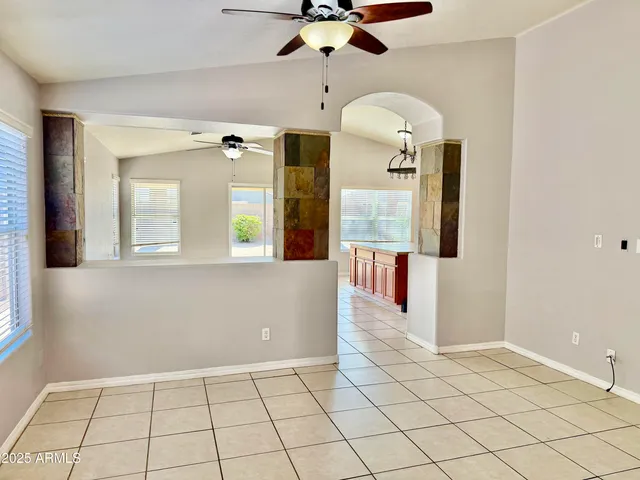 a kitchen with stainless steel appliances kitchen island granite countertop a refrigerator and a sink