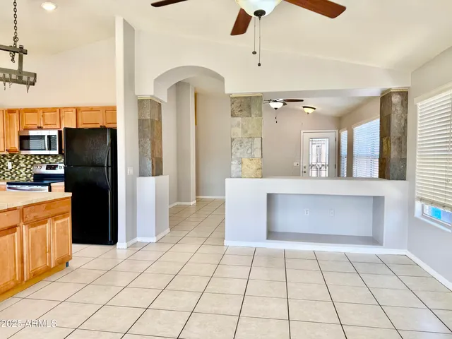 a kitchen with stainless steel appliances granite countertop a sink and a refrigerator
