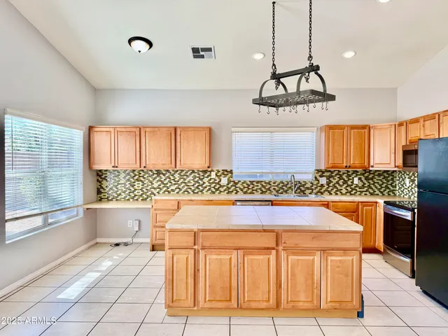 a kitchen with a refrigerator stove and sink