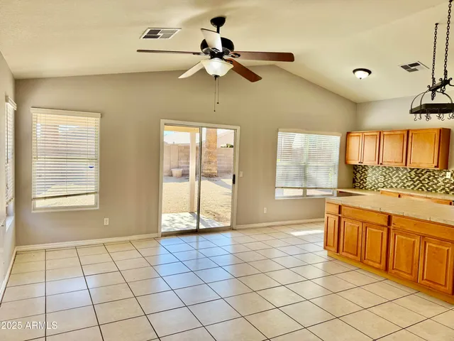 a kitchen with granite countertop a sink and a refrigerator