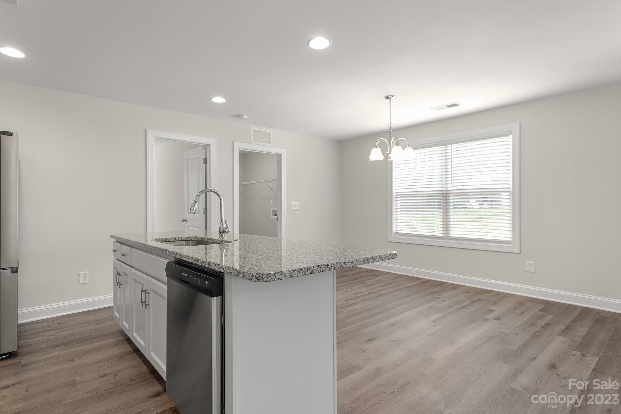 318 Springhill Lane Maiden, NC 28650 - Photo 14 of 40 a kitchen with stainless steel appliances granite countertop a sink a stove a refrigerator and island with wooden floor