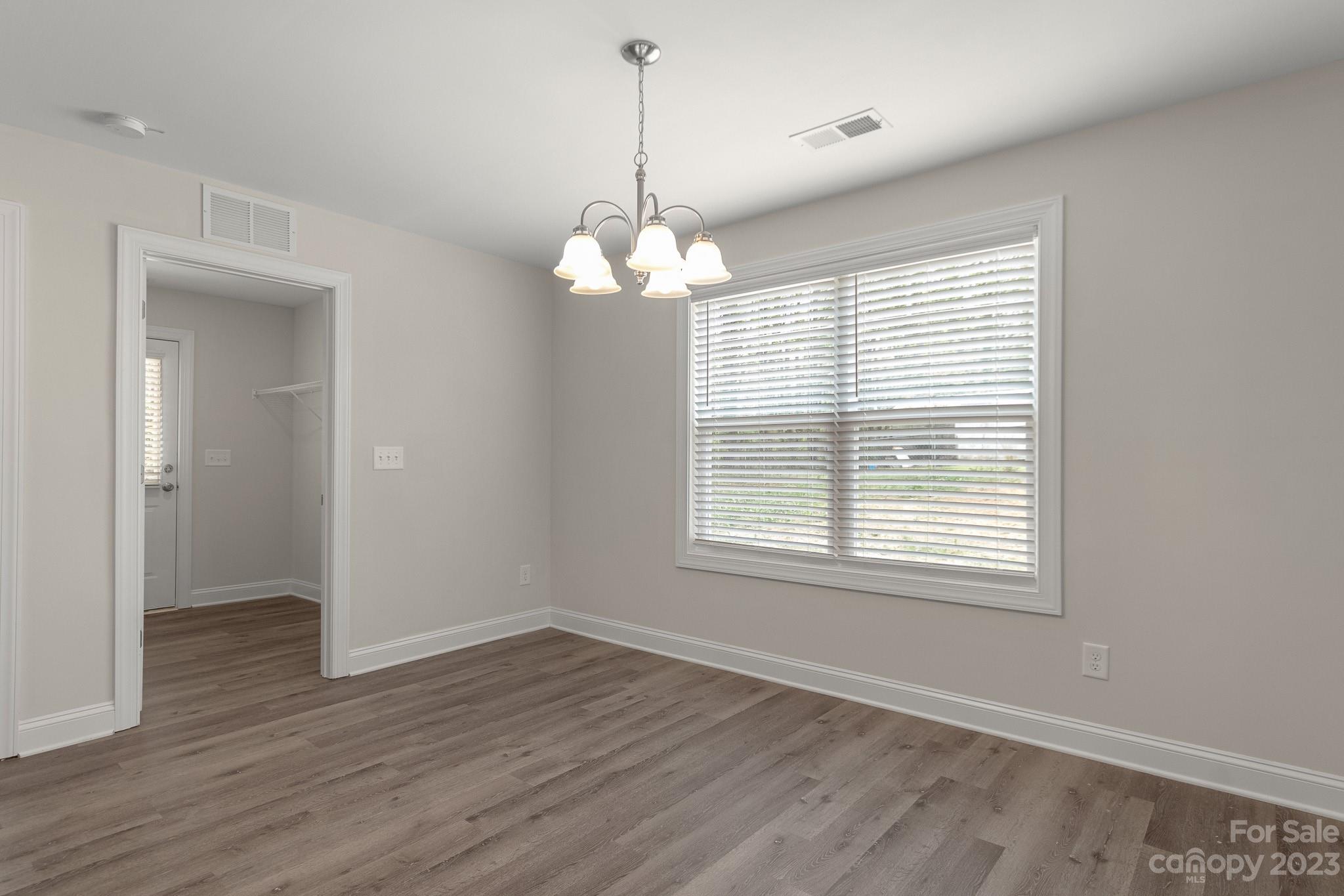 318 Springhill Lane Maiden, NC 28650 - Photo 16 of 40 a view of an empty room with wooden floor and a window
