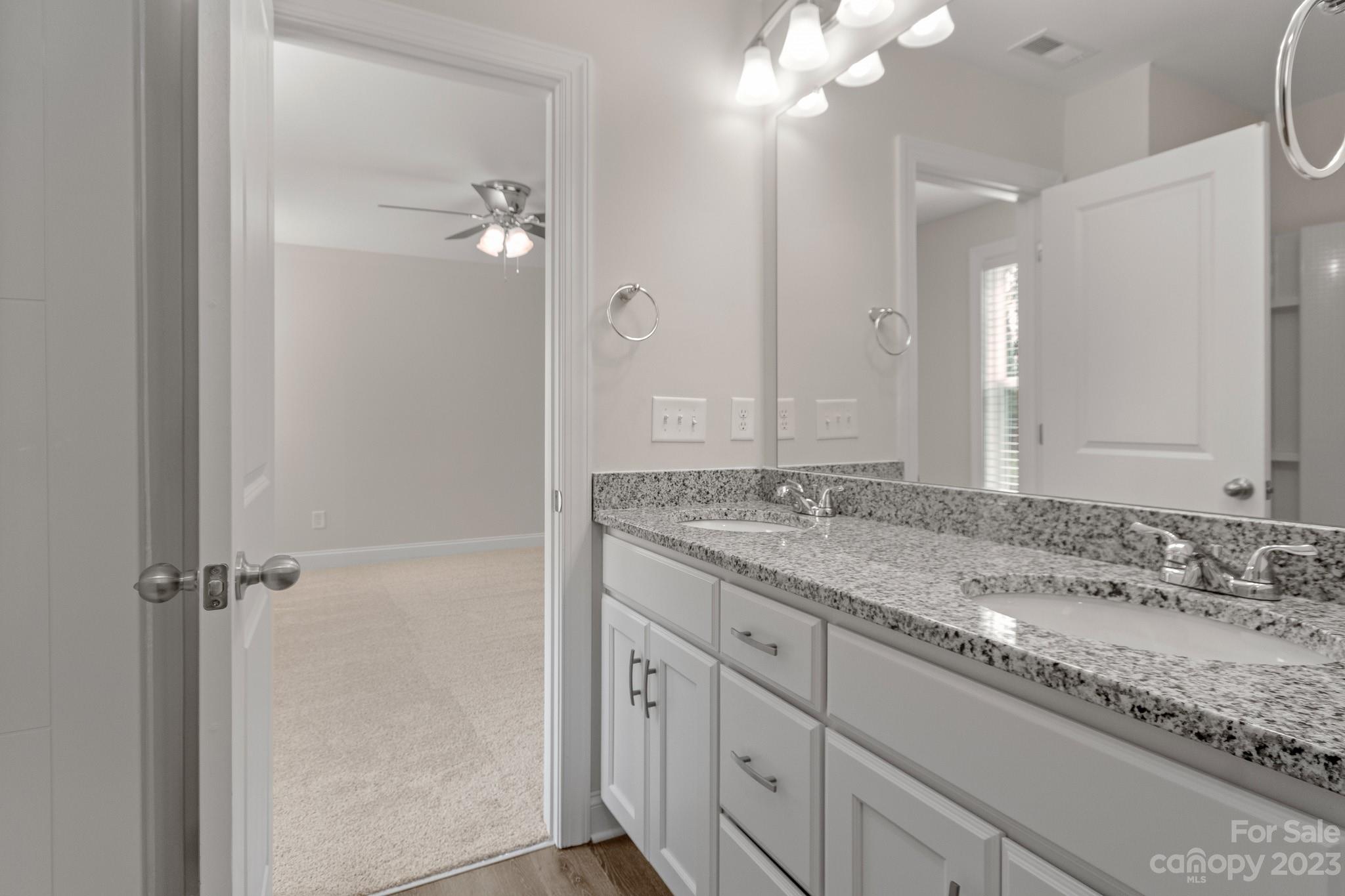318 Springhill Lane Maiden, NC 28650 - Photo 22 of 40 a bathroom with a granite countertop sink a large mirror and a shower