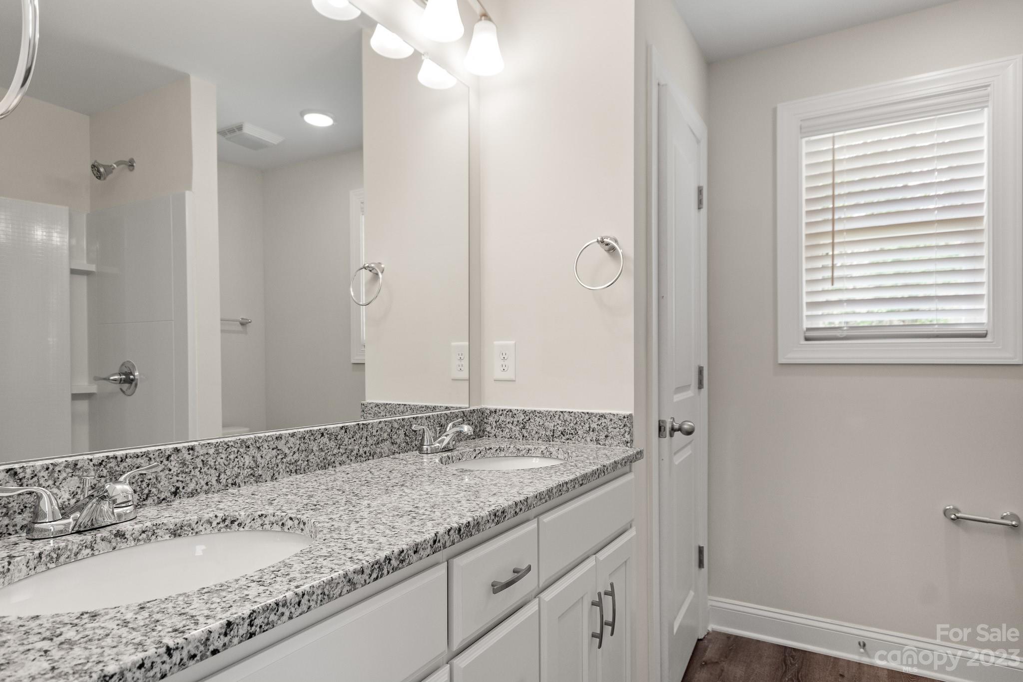 318 Springhill Lane Maiden, NC 28650 - Photo 23 of 40 a bathroom with a granite countertop sink and a mirror