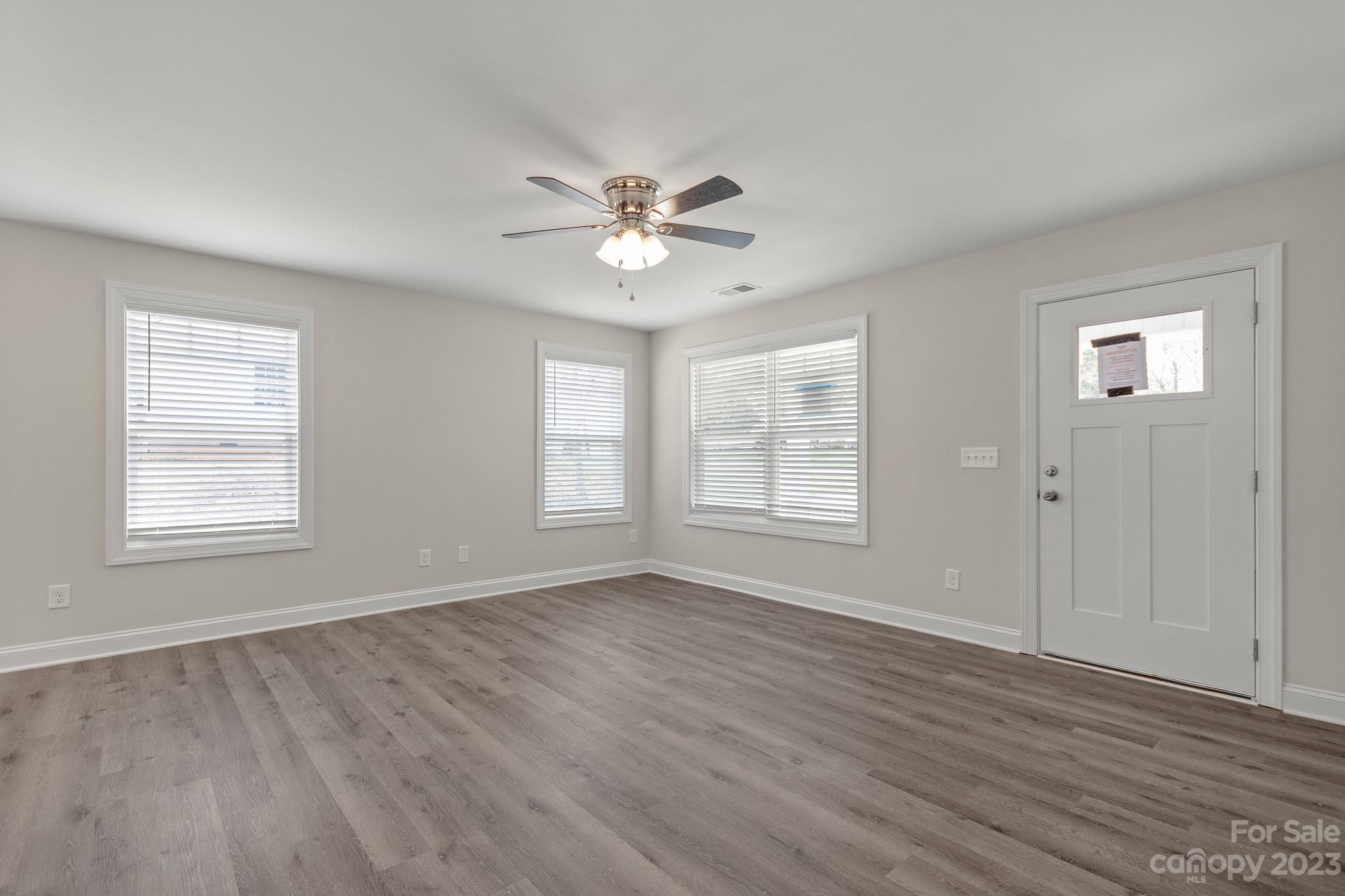 318 Springhill Lane Maiden, NC 28650 - Photo 5 of 40 a view of an empty room with a window and wooden floor