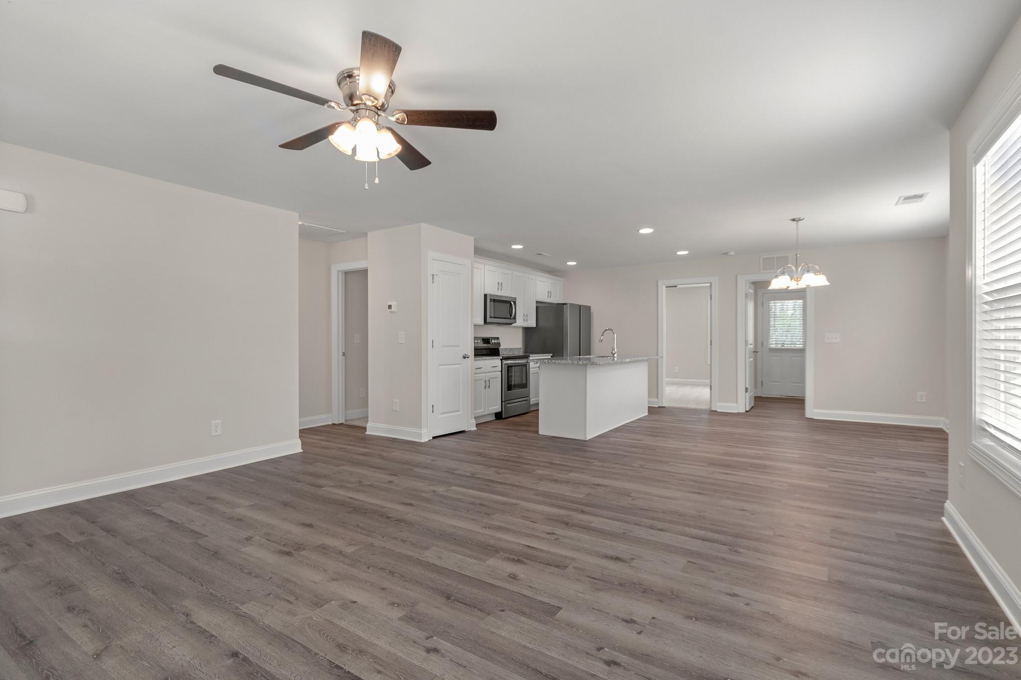 318 Springhill Lane Maiden, NC 28650 - Photo 7 of 40 a view of an empty room with wooden floor and a ceiling fan