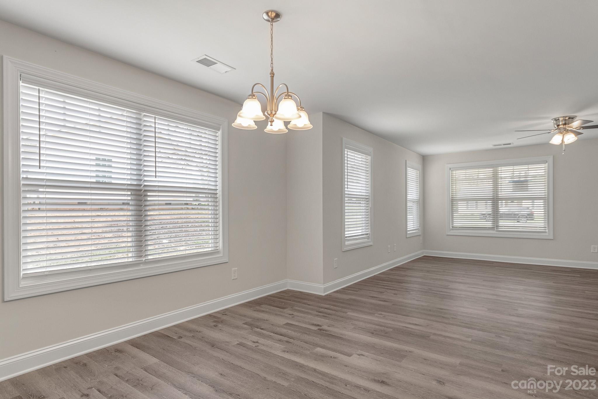 318 Springhill Lane Maiden, NC 28650 - Photo 8 of 40 a view of an empty room with wooden floor and a window