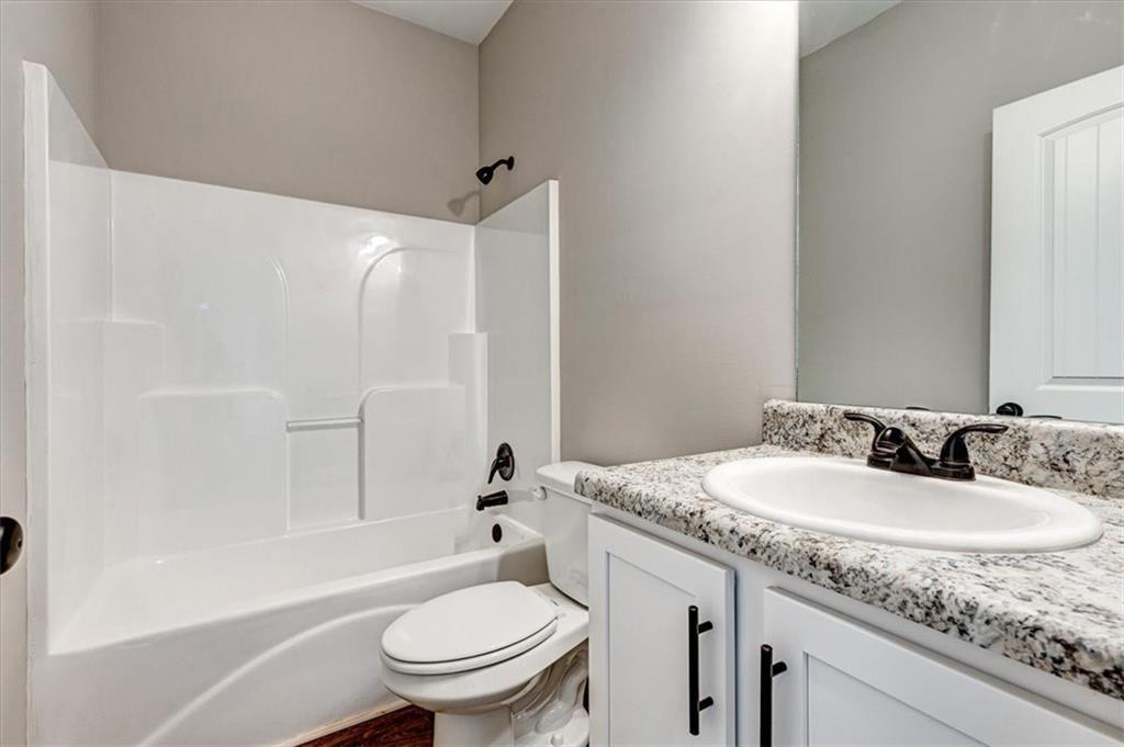 207 Loftis Road Temple, GA 30179 - Photo 12 of 14 a bathroom with a granite countertop sink toilet and shower