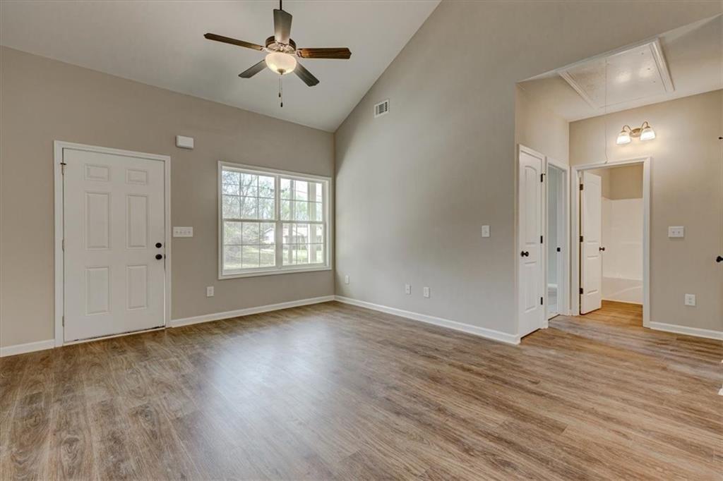 207 Loftis Road Temple, GA 30179 - Photo 5 of 14 a view of an empty room with window and wooden floor