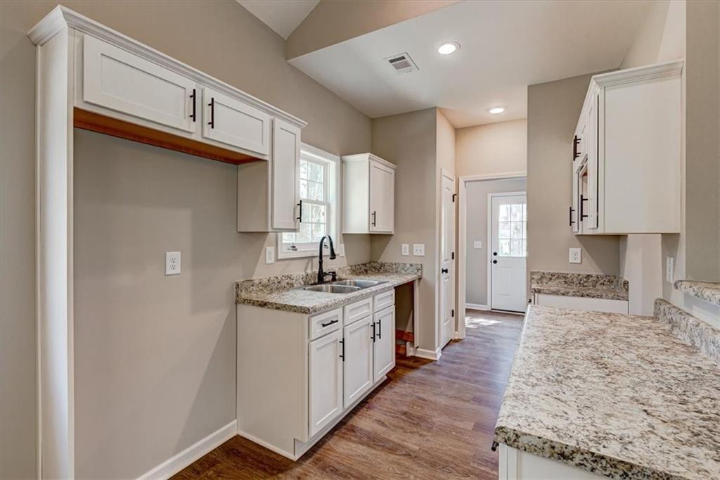 207 Loftis Road Temple, GA 30179 - Photo 8 of 14 a kitchen with a sink stove and cabinets