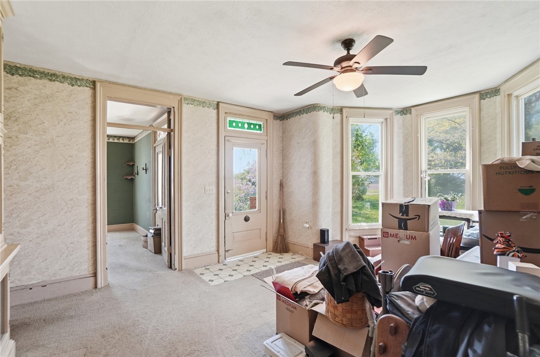 1444 Eagle City Road Springfield, OH 45504 - Photo 8 of 50 This bright room features a ceiling fan, bay windows, and carpet flooring.