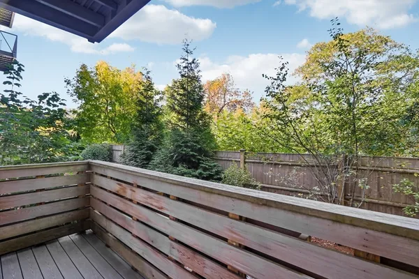 a view of balcony with wooden floor and fence