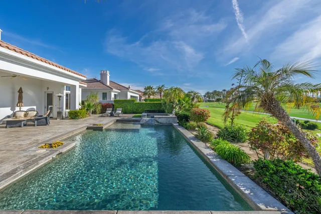 a view of a swimming pool with a yard
