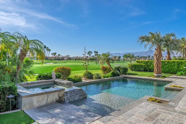 a view of a garden with plants and a lake view