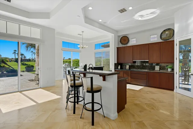 a kitchen with stainless steel appliances granite countertop a sink and a wooden floors