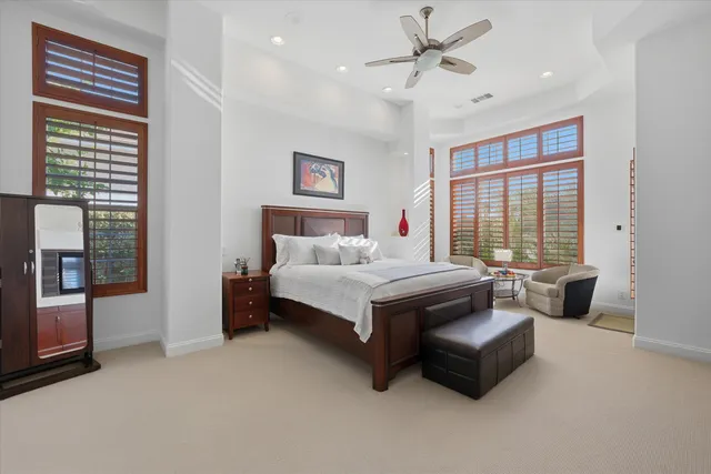 a spacious bathroom with a tub double sink and a large mirror