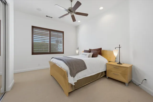 a bathroom with a sink toilet tub vanity and shower