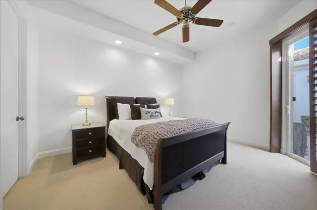 a bathroom with a granite countertop sink a toilet and a mirror