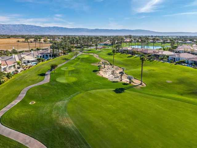 a view of a brick house with iron fence