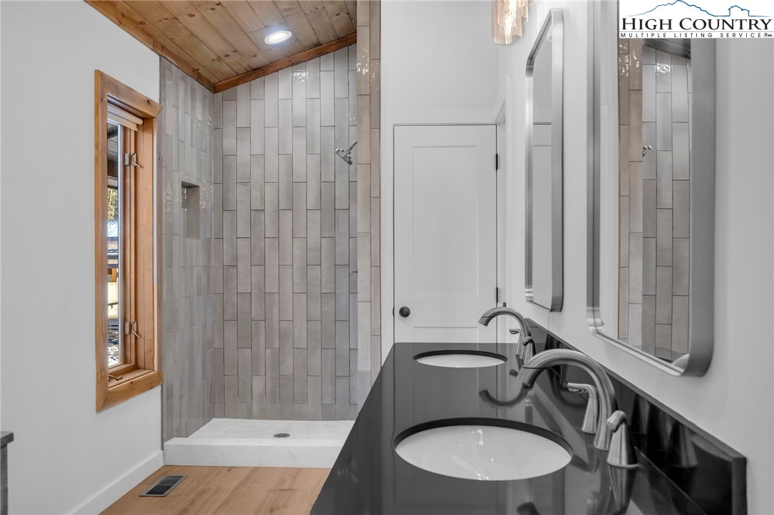 208 Meadow Loop Newland, NC 28657 - Photo 19 of 46 a bathroom with a sink a toilet and shower