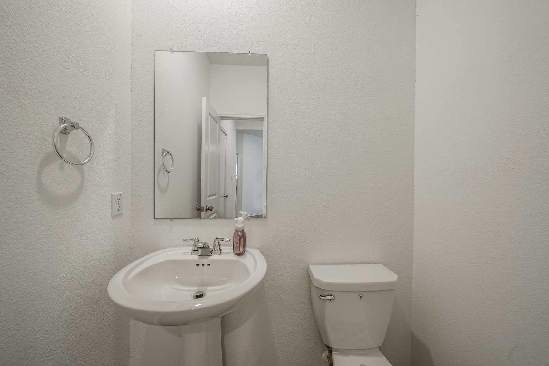 932 Mallow Road Leander, TX 78641 - Photo 12 of 34 A well-appointed half bath features a pedestal sink and simple, clean lines for everyday convenience.