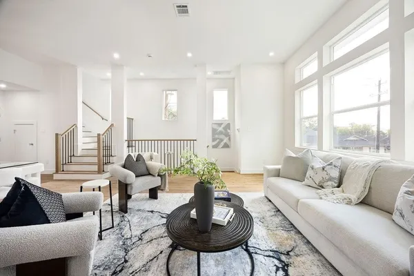 a living room with furniture and a large window