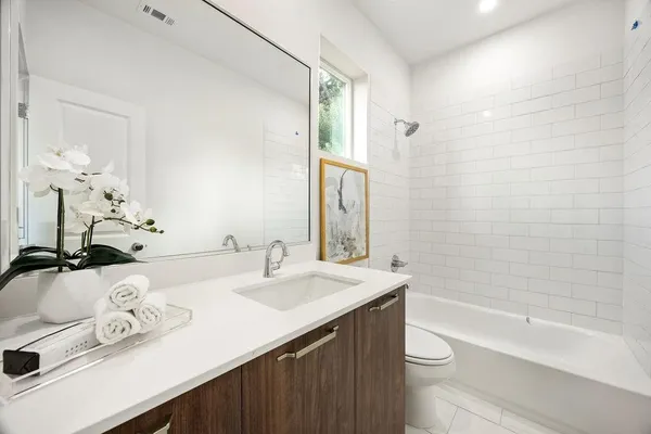 a bathroom with a sink a toilet and bathtub