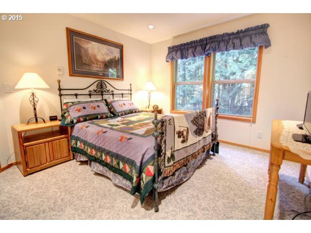 70385 East Zig Zag River Road Rhododendron, OR 97049 - Photo 11 of 16 a bed room with a bed and a painting on the wall