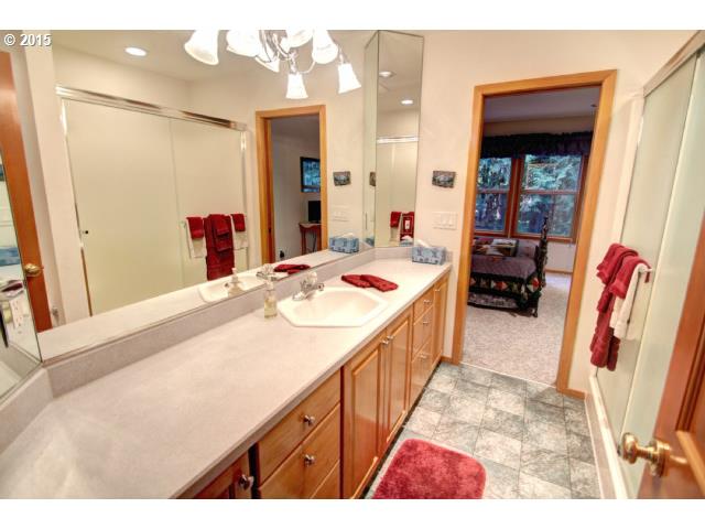 70385 East Zig Zag River Road Rhododendron, OR 97049 - Photo 12 of 16 a en suite bathroom with a sink a mirror and shower