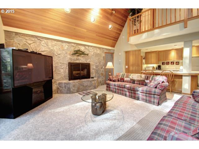 70385 East Zig Zag River Road Rhododendron, OR 97049 - Photo 4 of 16 a living room with furniture a flat screen tv and a fireplace