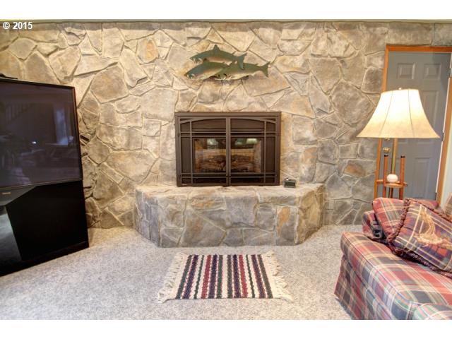 70385 East Zig Zag River Road Rhododendron, OR 97049 - Photo 5 of 16 a living room with a couch and a fireplace