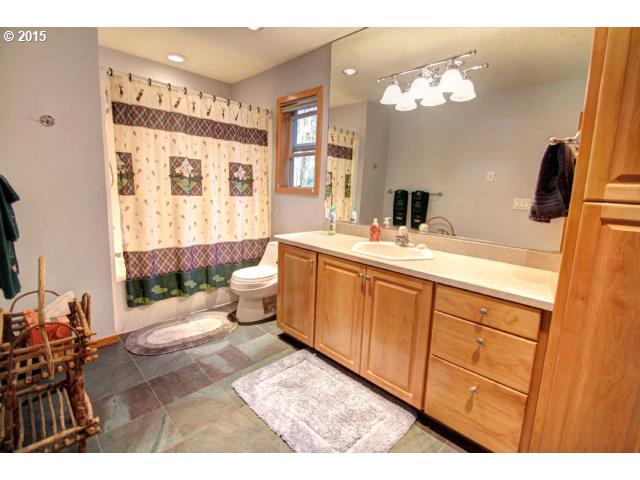 70385 East Zig Zag River Road Rhododendron, OR 97049 - Photo 10 of 16 a spacious bathroom with a double vanity sink a toilet a mirror and shower