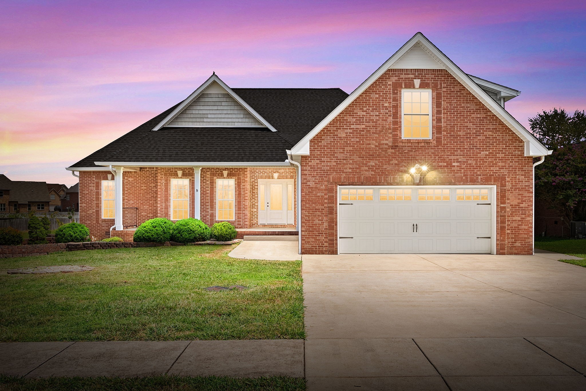 a front view of a house with a yard and garage