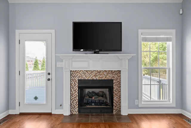 a living room with a fireplace and a flat screen tv
