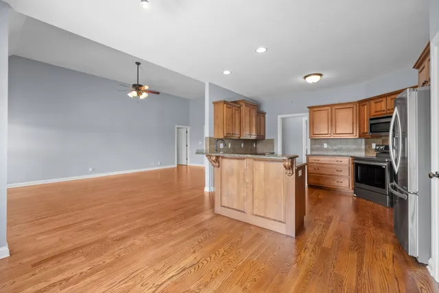 a kitchen with granite countertop a stove top oven and cabinets