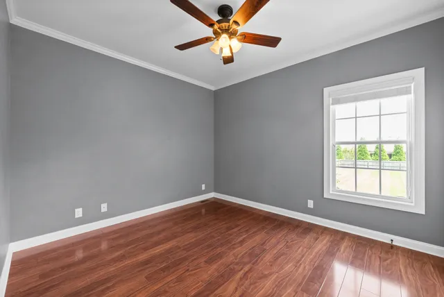 wooden floor in an empty room with a window