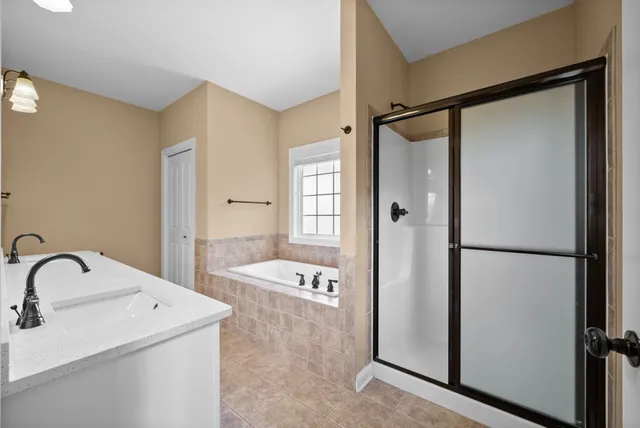 a bathroom with a tub and a window