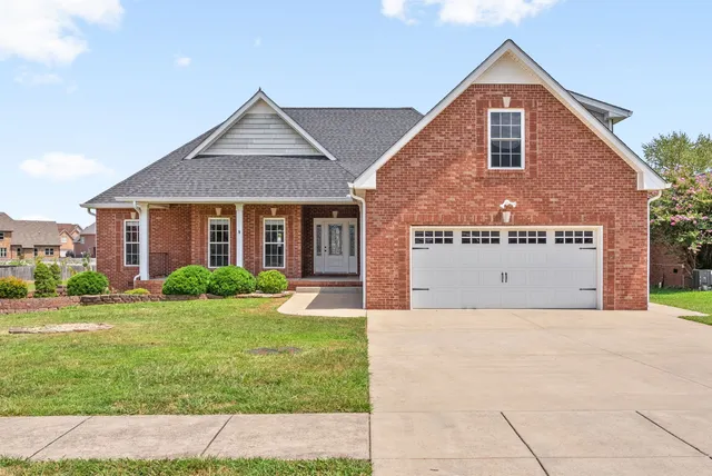 a front view of a house with a yard and garage