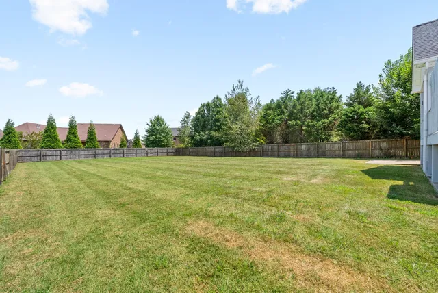 an aerial view of residential houses with outdoor space and river