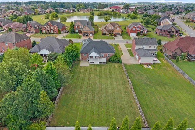 an aerial view of lake residential house with swimming pool and outdoor space