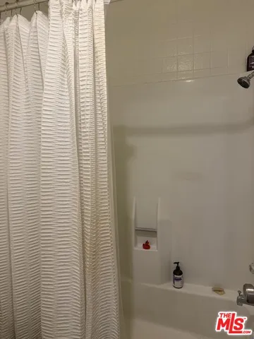 a bathroom with a bathtub and shower