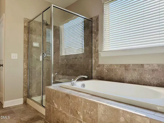 a bathroom with a bathtub and shower