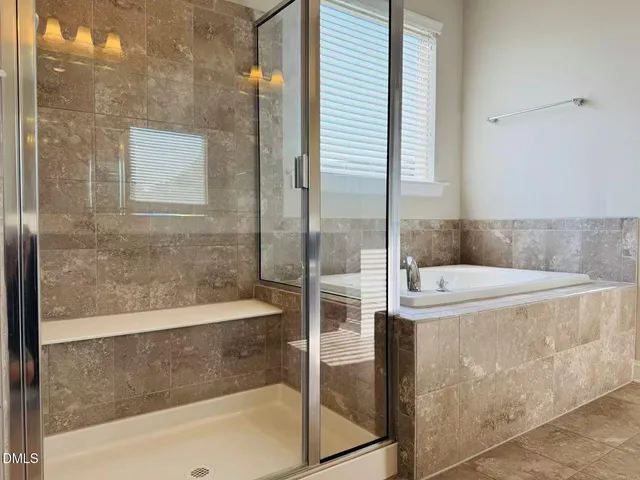 a bathroom with a bathtub and a shower