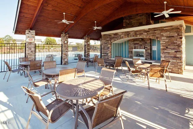 a view of a patio with table and chairs under an umbrella